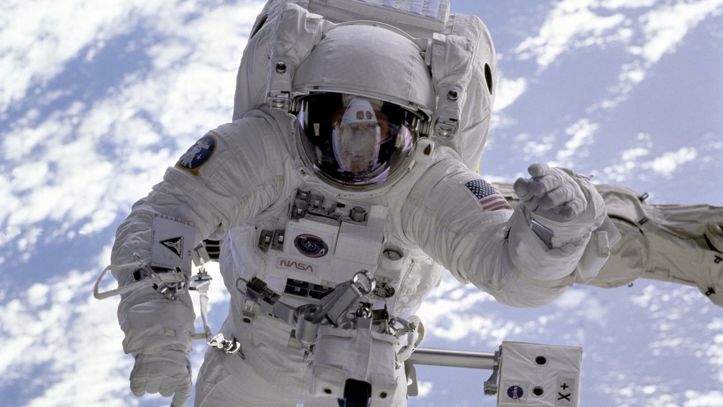 Das Bild zeigt einen Astronauten im erhellten Weltraum.